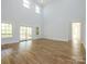 Spacious living room with high ceilings, hardwood floors, large windows, and access to the deck at 2008 Plain Field Dr, Bessemer City, NC 28016