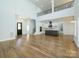 Open-concept living space with hardwood floors, a view of the loft area, and an adjacent modern kitchen at 2008 Plain Field Dr, Bessemer City, NC 28016
