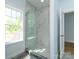 Marble tiled shower area with modern glass door and large window at 2008 Plain Field Dr, Bessemer City, NC 28016