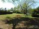Spacious backyard featuring storage and mature trees at 202 S Love Chapel Rd, Stanfield, NC 28163