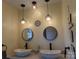 Stylish bathroom featuring double vessel sinks, round mirrors, and decorative pendant lighting at 202 S Love Chapel Rd, Stanfield, NC 28163
