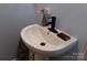 A pedestal sink with a black faucet, soap dish, and a small vase of flowers at 202 S Love Chapel Rd, Stanfield, NC 28163