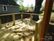 A new wooden deck with metal wire railing overlooks a serene backyard at 202 S Love Chapel Rd, Stanfield, NC 28163