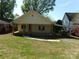 Quaint exterior of a light yellow house with a covered porch and ample green lawn at 202 S Love Chapel Rd, Stanfield, NC 28163
