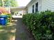 Home exterior showing covered parking, landscaped walkway, and well-maintained features at 202 S Love Chapel Rd, Stanfield, NC 28163
