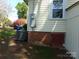 Exterior of home with brick foundation, siding, air conditioner and basement access at 202 S Love Chapel Rd, Stanfield, NC 28163