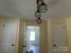 Hallway with modern lighting, classic white doors, and updated flooring at 202 S Love Chapel Rd, Stanfield, NC 28163