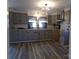Spacious kitchen featuring shaker cabinets, modern lighting and beautiful flooring at 202 S Love Chapel Rd, Stanfield, NC 28163