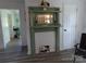 Living room featuring a decorative fireplace with mirror and updated flooring at 202 S Love Chapel Rd, Stanfield, NC 28163