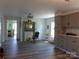 Open living space featuring modern flooring, a fireplace, and a seating area at 202 S Love Chapel Rd, Stanfield, NC 28163