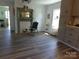 Cozy living room with decorative fireplace, modern flooring, and built in cabinets at 202 S Love Chapel Rd, Stanfield, NC 28163