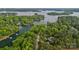 Aerial view showcases a tree-lined neighborhood with lake access and multiple private docks at 208 Grasshopper Cir, Mooresville, NC 28117