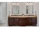 Bathroom features double sinks with granite countertop and wooden cabinets at 208 Grasshopper Cir, Mooresville, NC 28117