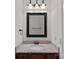 Bathroom featuring granite sink and decorative mirror above the vanity at 208 Grasshopper Cir, Mooresville, NC 28117