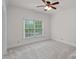 Empty bedroom with neutral paint, carpet, ceiling fan, and large window at 208 Grasshopper Cir, Mooresville, NC 28117
