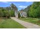 Charming home with lush landscaping, well-manicured lawn, long driveway, mature trees and a 3-car garage at 208 Grasshopper Cir, Mooresville, NC 28117