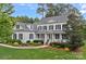 Charming white two-story home with black shutters, a welcoming porch, and manicured landscaping at 208 Grasshopper Cir, Mooresville, NC 28117