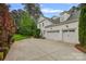 Three-car garage with paved driveway, ample parking, exterior lights, and basketball hoop at 208 Grasshopper Cir, Mooresville, NC 28117