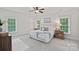 Spacious main bedroom featuring neutral walls, two windows, carpet, and decorative furniture at 208 Grasshopper Cir, Mooresville, NC 28117