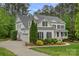Side view of a white two-story home with an attached garage, complemented by lush landscaping at 208 Grasshopper Cir, Mooresville, NC 28117