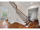 Elegant staircase with dark wood and wrought iron banister, leading to the upper level of the home at 208 Grasshopper Cir, Mooresville, NC 28117
