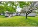 Wide shot of the backyard features a gentle slope and a shed in the far back at 220 Tomberlin Rd, Mount Holly, NC 28120