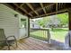View from covered porch shows the railing, yard, and a small shed in the back at 220 Tomberlin Rd, Mount Holly, NC 28120