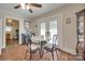 Cozy dining area featuring a table with decorative chairs, hardwood floors, and natural light from glass paneled doors at 220 Tomberlin Rd, Mount Holly, NC 28120