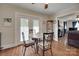 Well-lit dining area with hardwood floors, an inviting table setup, and easy access to the living room at 220 Tomberlin Rd, Mount Holly, NC 28120