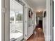 Inviting entryway with hardwood floors, and a bright view of the front porch and neighborhood beyond at 220 Tomberlin Rd, Mount Holly, NC 28120