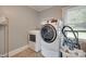 Laundry room with modern washer and dryer next to a large bright window at 220 Tomberlin Rd, Mount Holly, NC 28120