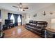 Bright living room with a sofa, a TV, hardwood floors, and windows that provide natural light at 220 Tomberlin Rd, Mount Holly, NC 28120