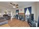 Comfortable living room features a ceiling fan, cozy furniture, a fireplace, and windows with dark curtains at 220 Tomberlin Rd, Mount Holly, NC 28120