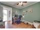 Bright green office features a traditional desk, art, and an exterior door at 220 Tomberlin Rd, Mount Holly, NC 28120