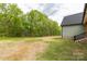 A view of the back of the house, which features a grassy lawn and privacy at 2212 University Dr, Lancaster, SC 29720