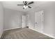 A light filled bedroom with carpet, a ceiling fan, and closet doors at 2212 University Dr, Lancaster, SC 29720