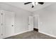 A light filled bedroom with carpet, a ceiling fan, and closet doors at 2212 University Dr, Lancaster, SC 29720