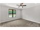 A bright bedroom featuring a ceiling fan and a large window that provides plenty of natural light at 2212 University Dr, Lancaster, SC 29720