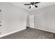 A spacious bedroom with neutral walls, carpet flooring, and a ceiling fan at 2212 University Dr, Lancaster, SC 29720