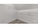 A simple closet with installed shelving and carpeted floor in a neutral color at 2212 University Dr, Lancaster, SC 29720