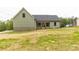 Exterior shot of a single Gathering home showcasing the lawn and covered porch with wood columns at 2212 University Dr, Lancaster, SC 29720