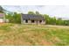 Well-maintained house featuring green siding, a dark roof, and a spacious lawn at 2212 University Dr, Lancaster, SC 29720