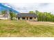Charming single-story home with craftsman columns, green siding, and a large front yard at 2212 University Dr, Lancaster, SC 29720