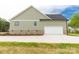 Side-angled view of a home showing the attached, two-car garage and large driveway at 2212 University Dr, Lancaster, SC 29720