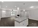 Bright living room with a kitchen island, fireplace, dark floors, and plenty of natural light at 2212 University Dr, Lancaster, SC 29720