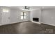 Inviting living room with fireplace, dark floors, large window, and bright natural light at 2212 University Dr, Lancaster, SC 29720