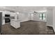 Open layout featuring a modern kitchen with island, hardwood floors, and a bright atmosphere at 2212 University Dr, Lancaster, SC 29720
