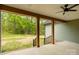 Covered porch with stained wood beams overlooks large backyard with privacy at 2212 University Dr, Lancaster, SC 29720