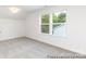 Spacious bedroom with neutral carpet and large windows overlooking a green yard at 24558 Blue Heron Cir # 402, Lancaster, SC 29720