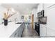 Open kitchen with stainless steel appliances, spacious island, and hardwood flooring for a modern feel at 24558 Blue Heron Cir # 402, Lancaster, SC 29720